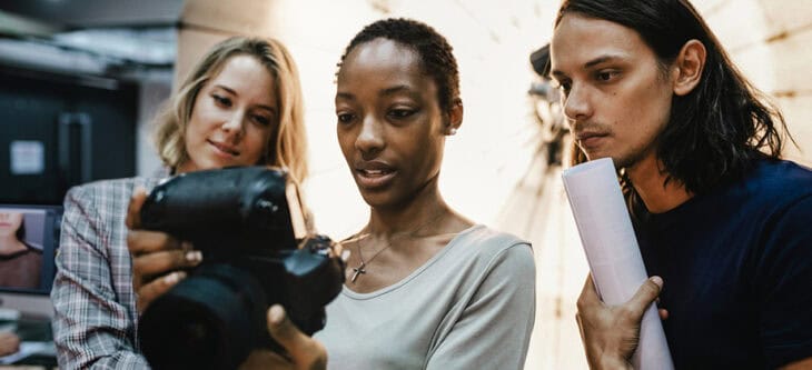 Photographers looking at photos on a camera