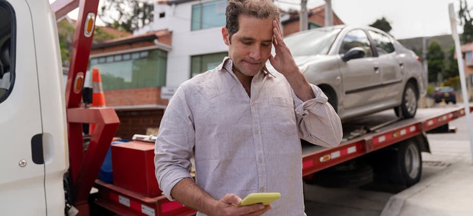 Man having problems with his car and calling roadside assistance