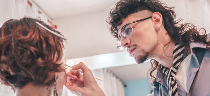 Makeup artist applying makeup on model's face