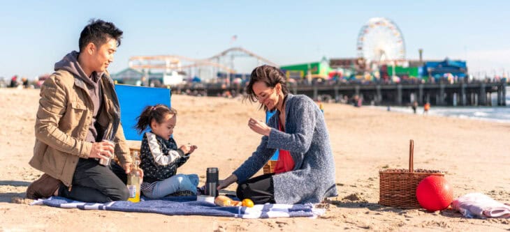Family playing on beach at Santa Monica Pier