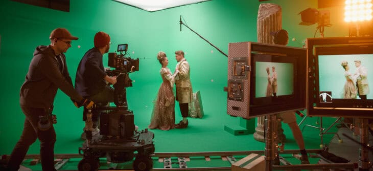 Female Director Controls Cameraman Shooting Green Screen Scene with Two Actors Talented Wearing Renaissance Clothes Talking.