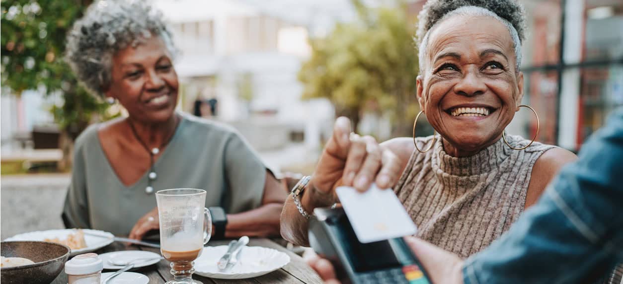 Senior woman making credit card payment
